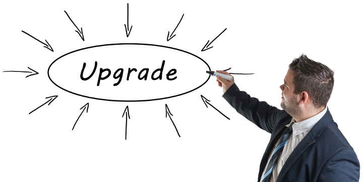 Upgrade - young businessman drawing information concept on whiteboard.